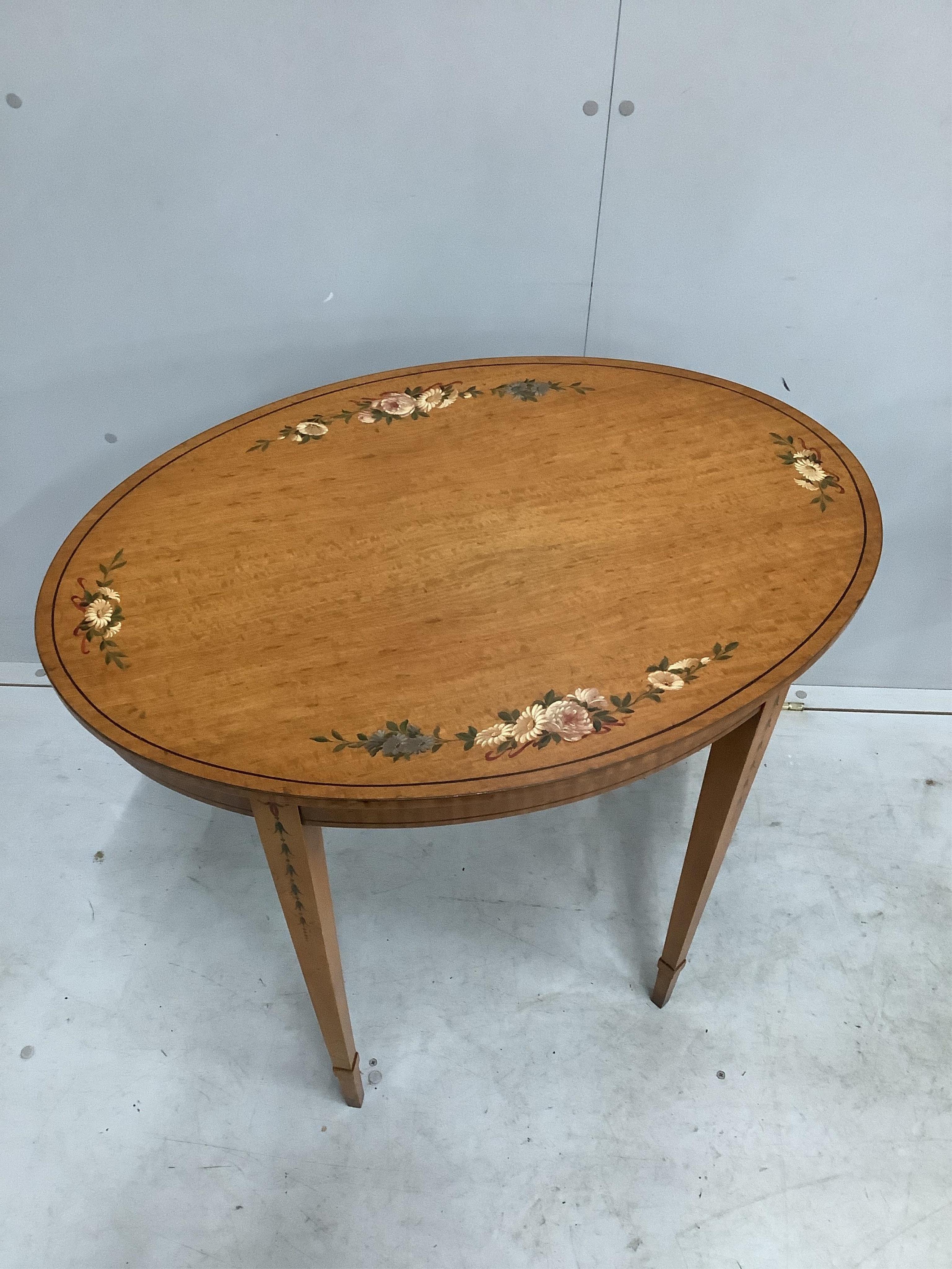 A pair of reproduction Sheraton style painted oval satinwood occasional tables, width 74cm, depth 52cm, height 74cm. Condition - good